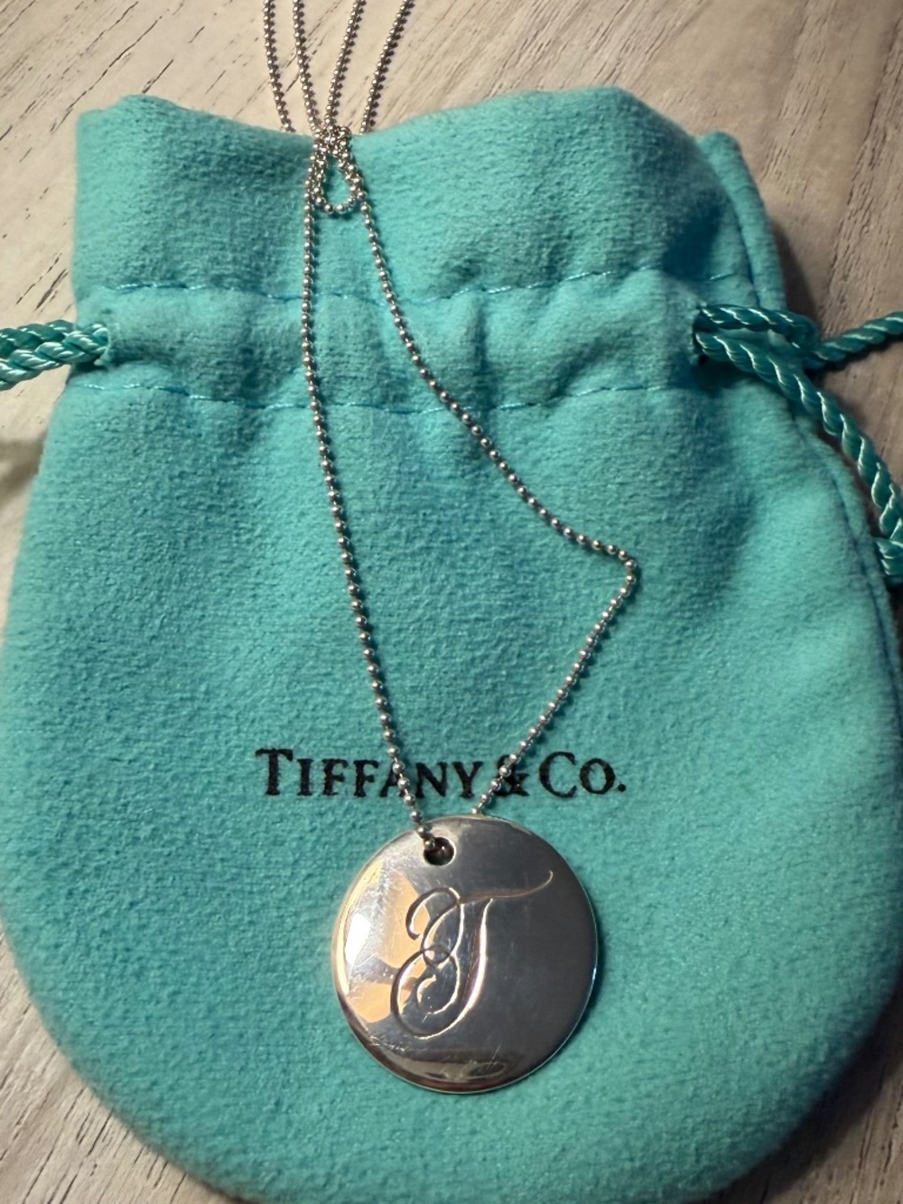 Tiffany & Co. “T” initial circle disc